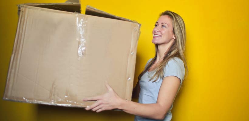 ecommerce packaging A young lady holding a large eCommerce packaging box