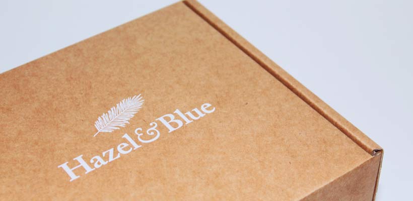 personalised-packaging A brown kraft cardboard box with white branding