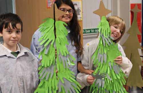 Cardboard Christmas trees Primary school students with decorated Cardboard Christmas trees