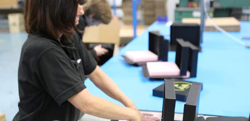 labour-costs-packaging A factory worker assembling packaging