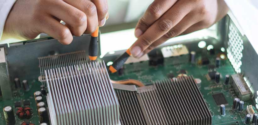 A person fixing an electronic assembly