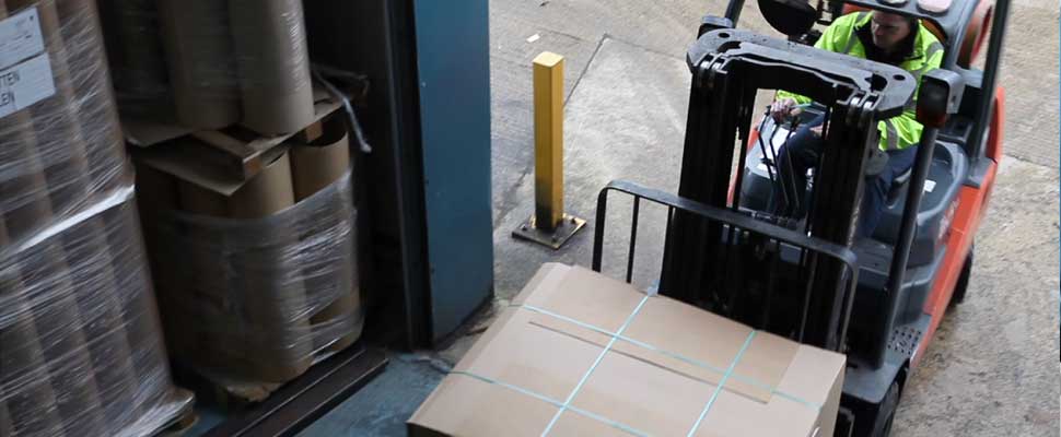 Packaging suppliers Sheets of corrugated cardboard being moved by a forklift