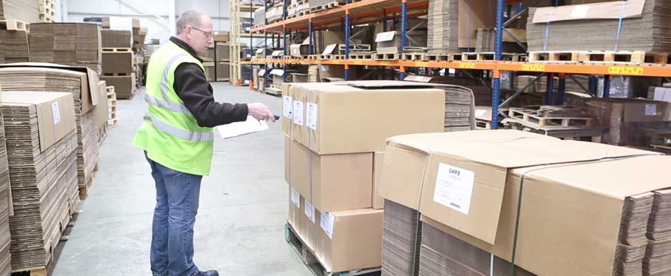 Packaging being scanned with a barcode reader in a warehouse
