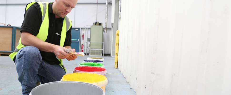 A factory working mixing inks for printed packaging