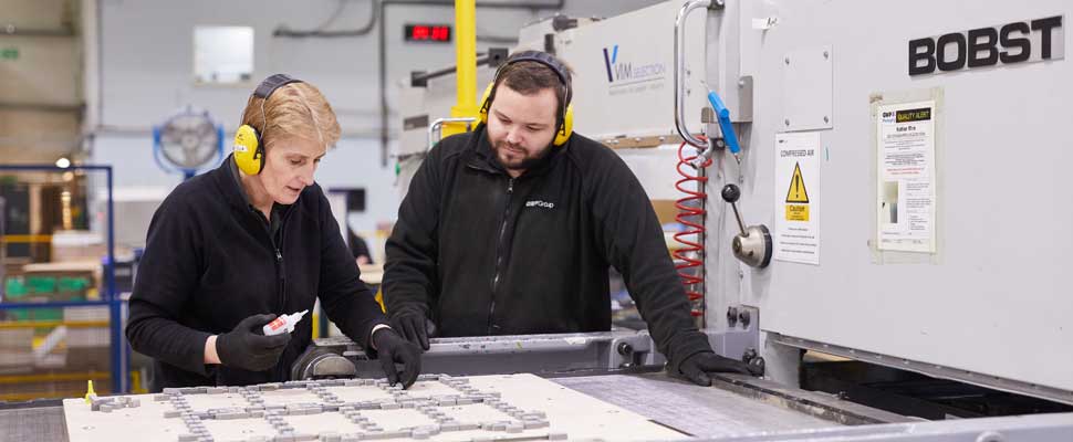 wellbeing Two production operatives discussing a job in a factory