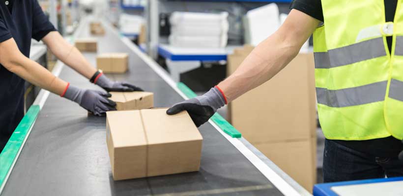 Plastic free packaging on a conveyor belt in a warehouse