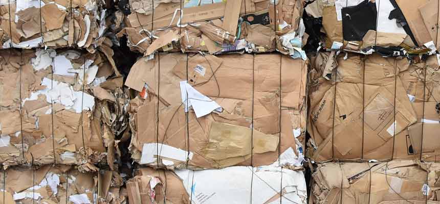 How is cardboard recycled? Stacks of cardboard about to be recycled.