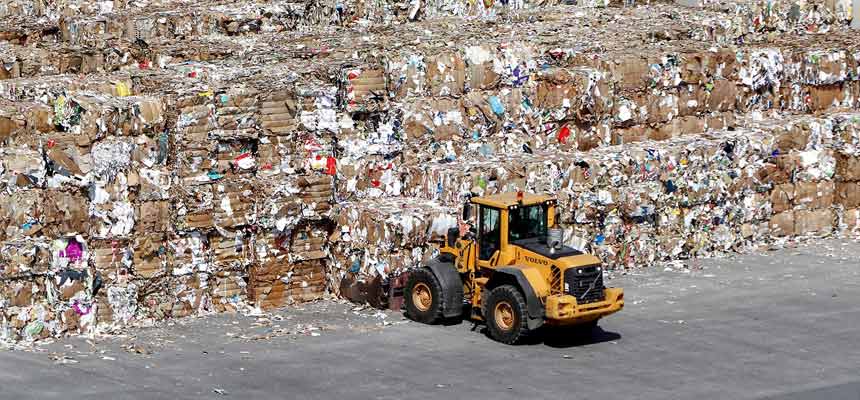 Sorting cardboard for recycling An industrial vehicle sorting large volumes of cardboard material.