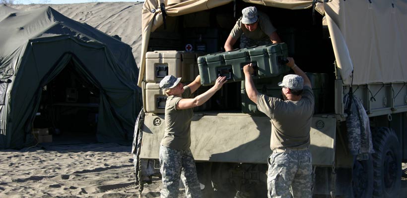 Defence standard packaging Military personnel unloading packing cases from an army vehicle.
