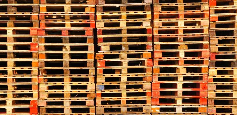 Custom pallet manufacturer A large stack of ISPM15 compliant wooden pallets