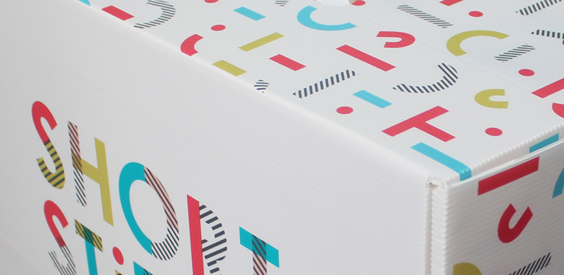 A white Correx box with brightly coloured printing