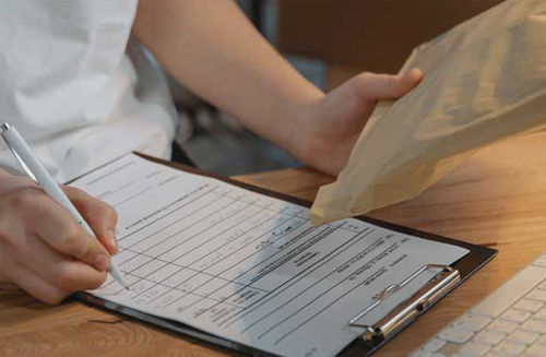 A person with a clipboard and packaging