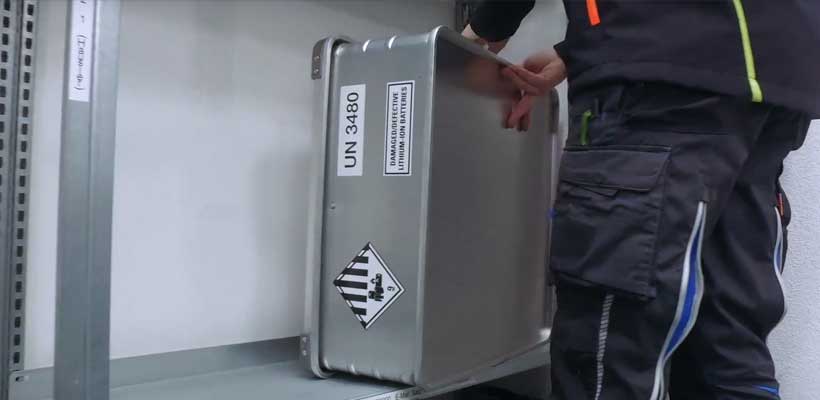 A person loading battery packaging.