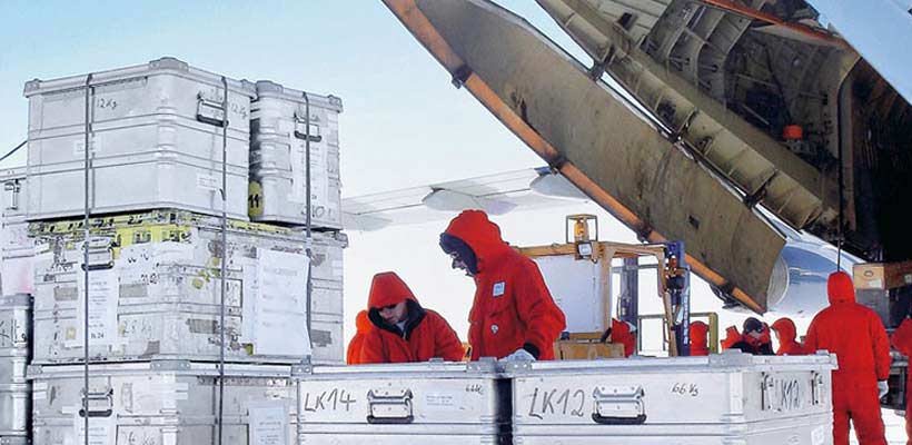 Cold weather cases A team of people unloading aluminium cases in cold weather.