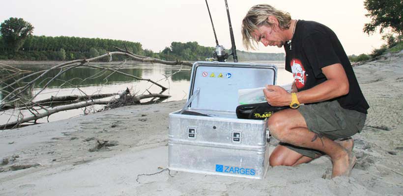 Zarges K470 kit box A person on a beach taking equipment out of a Zarges K470 kit box.