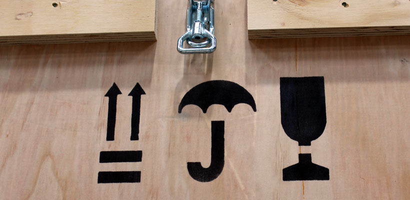 Handling symbols on a wooden crate.