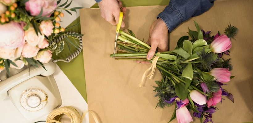 A florist prepping flowers for shipping