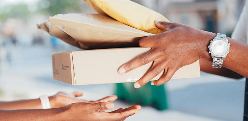 Subscription box packaging types A person handing over a number of postal boxes and envelopes.