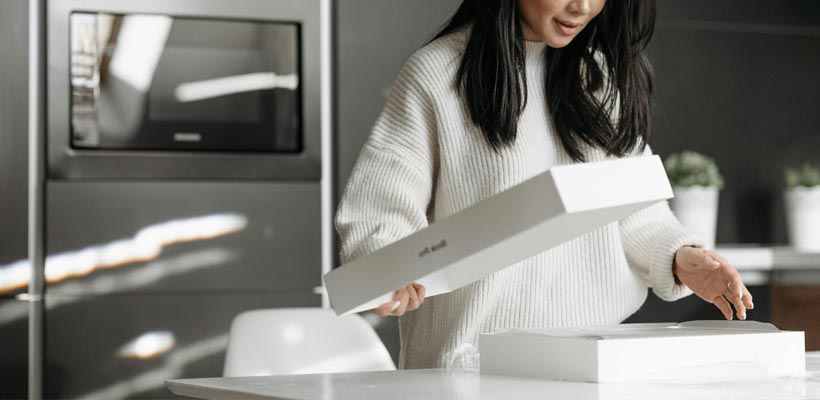 Luxury packaging for subscription businesses A person opening a luxury subscription box.