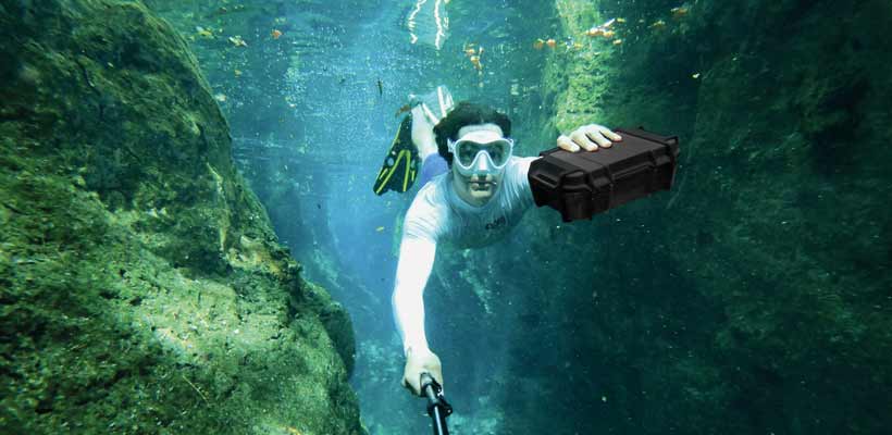 Peli Ruck case A diver underwater holding a Peli Ruck case
