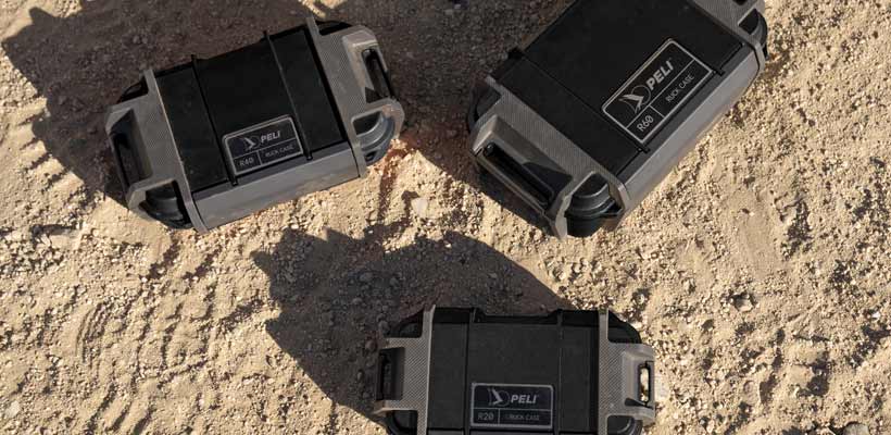 Pelican Ruck case Three Pelican Ruck cases on a sandy floor