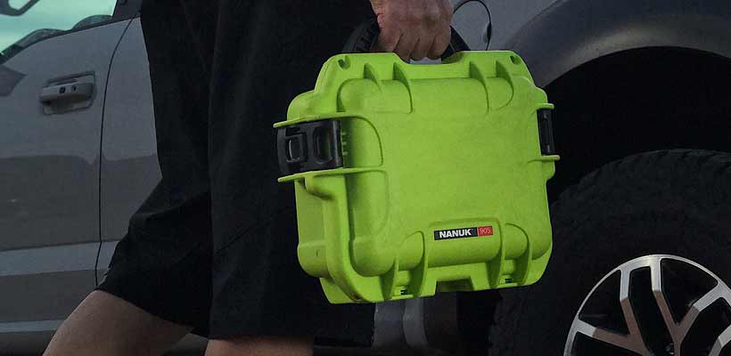 Small Nanuk case A person carrying a small Nanuk case