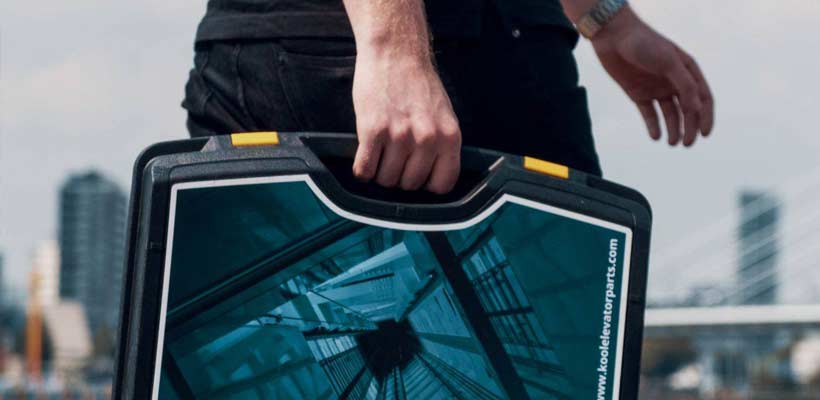 A person carrying a plastic case with intricate graphics.