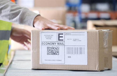A person packing an ecommerce order in a warehouse